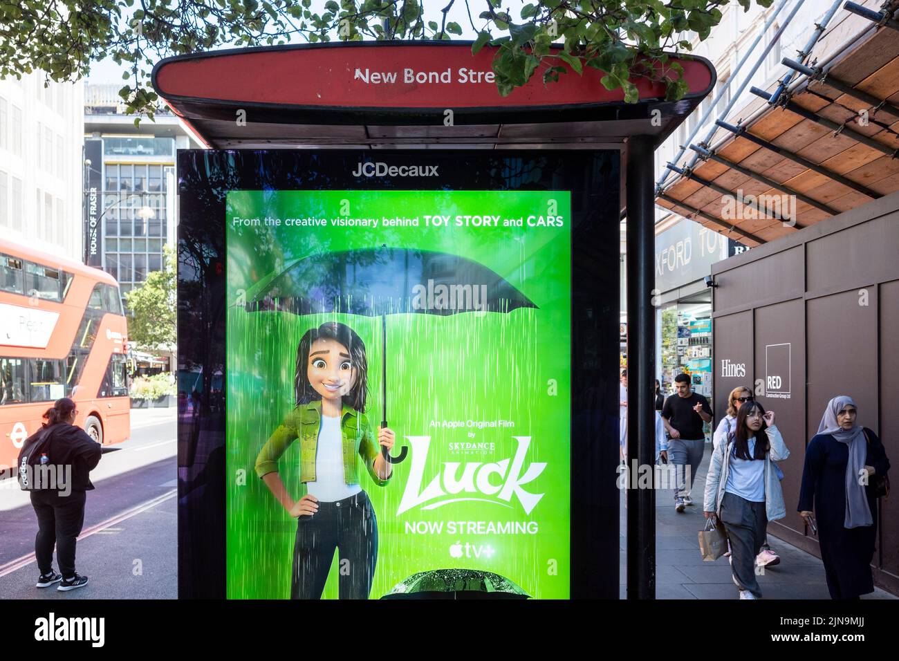 London, UK.  10 August 2022.  A sign on a bus stop in Oxford Street promotes a new film called ‘Luck’ which is streaming on Apple TV. Many parts of the UK have endured the driest July on record and an amber warning for extreme heat has been issued by the Met Office for the rest of this week as the heatwave and absence of rainfall continues. .  Credit: Stephen Chung / Alamy Live News Stock Photo