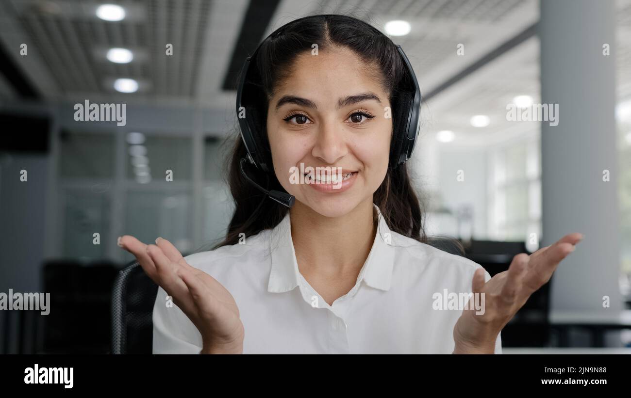 Close-up young friendly woman operator telemarketing sales agent talking to webcam smiling businesswoman looking at camera communicating via video Stock Photo