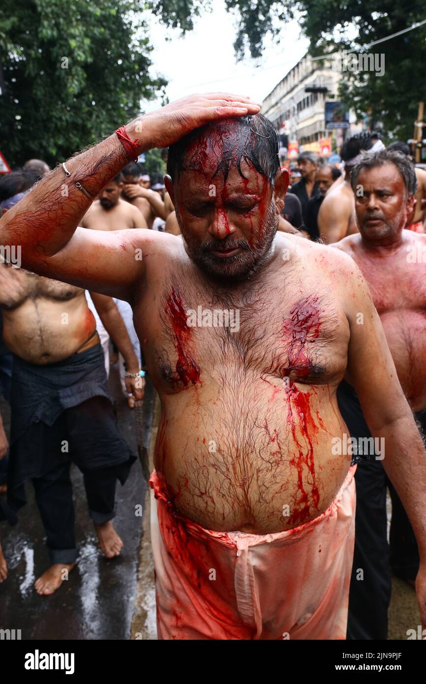 Kolkata, India. 09th Aug, 2022. (EDITORS NOTE: Image contains graphic content) Shi'ite Muslim mourners flagellate themselves during a Muharram procession to mark Ashura in Kolkata. After a gap of two years due to COVID-19 related restrictions, this year the mourners were permitted to organise processions in the city. (Photo by Dipa Chakraborty/Pacific Press) Credit: Pacific Press Media Production Corp./Alamy Live News Stock Photo