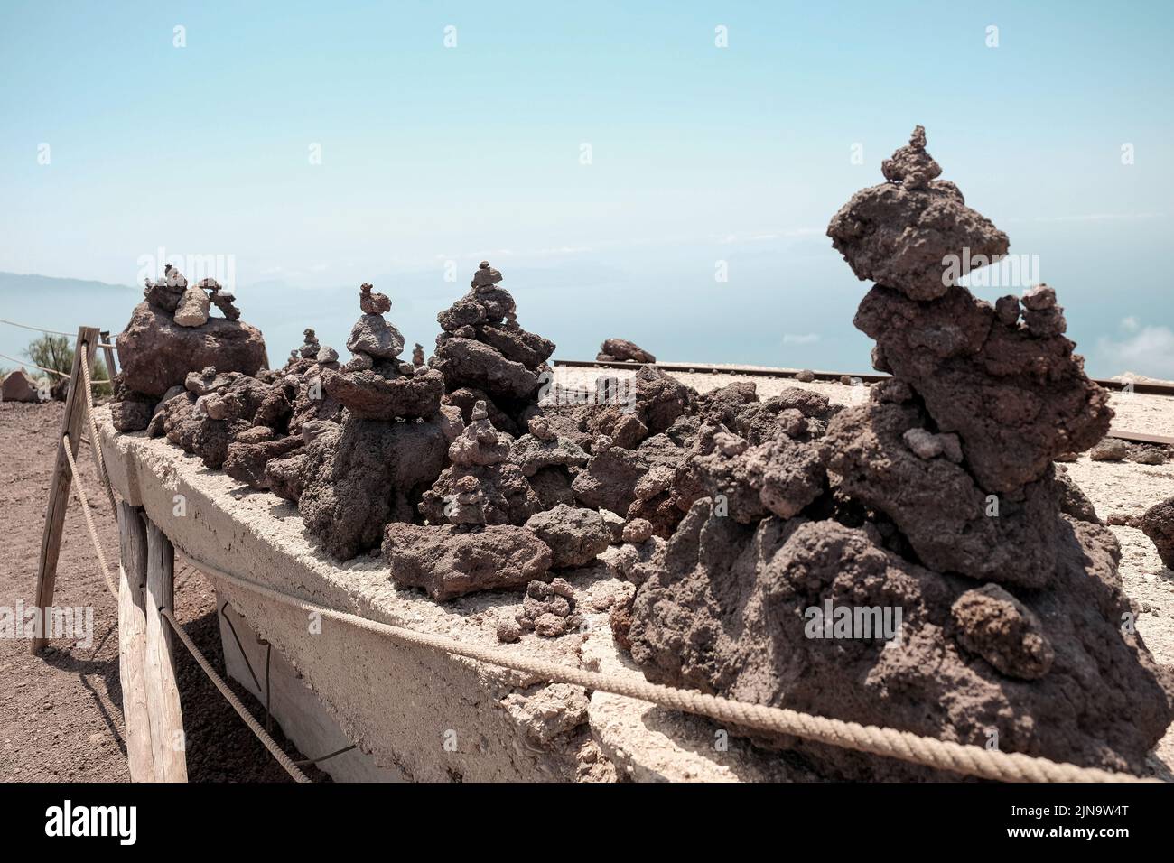 Small piles of volcanic rock made and left  by tourists on the top of Mount Vesuvius Italy. Stock Photo