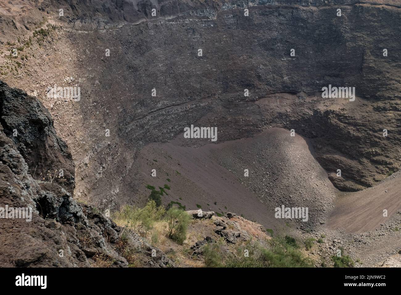 Close-ups around the cone at the top of Mount Vesuvius Italy showing the different layers of rock looking towards the closed vent. Stock Photo