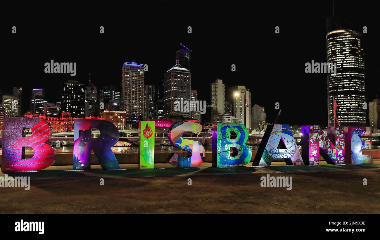 134 Brisbane sign lit up at night with the city CBD skyline in the background. Queensland-Australia. Stock Photo