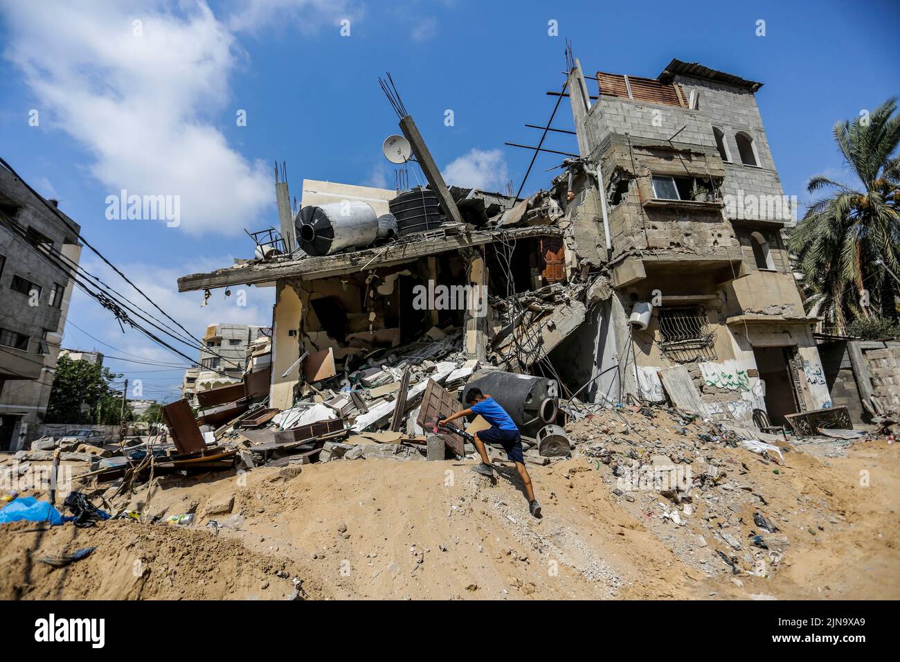 Gaza City, The Gaza Strip. August 10, 2022, Gaza City, The Gaza Strip, Palestine: A Palestinian inspects the rubble of his destroyed house after Israeli attacks on Gaza, 10 August 2022. On 07 August at 23:30 local time (20:30 GMT), Israel and Palestinian militants in Gaza confirmed an Egyptian-mediated ceasefire which came into effect after three days of exchanging rocket attacks and airstrikes resulting in the death of at least 44 Palestinians and injury of 360 others, according to the Palestinian Ministry of Health. Credit: ZUMA Press, Inc./Alamy Live News Stock Photo