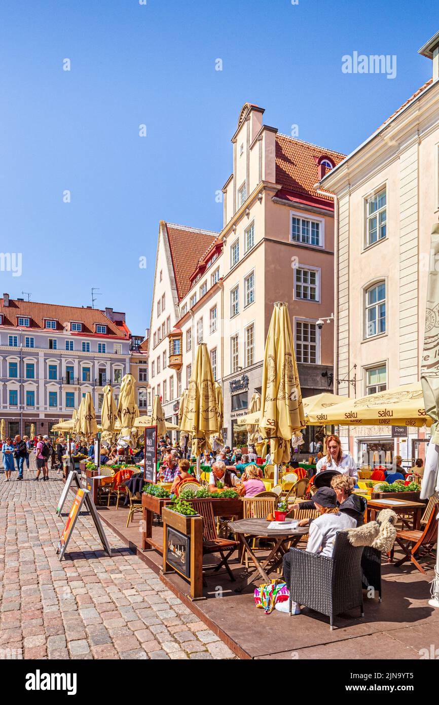 Al fresco cafes in the bustling Town Hall Square in the Old Town of Tallinn the capital city of Estonia Stock Photo