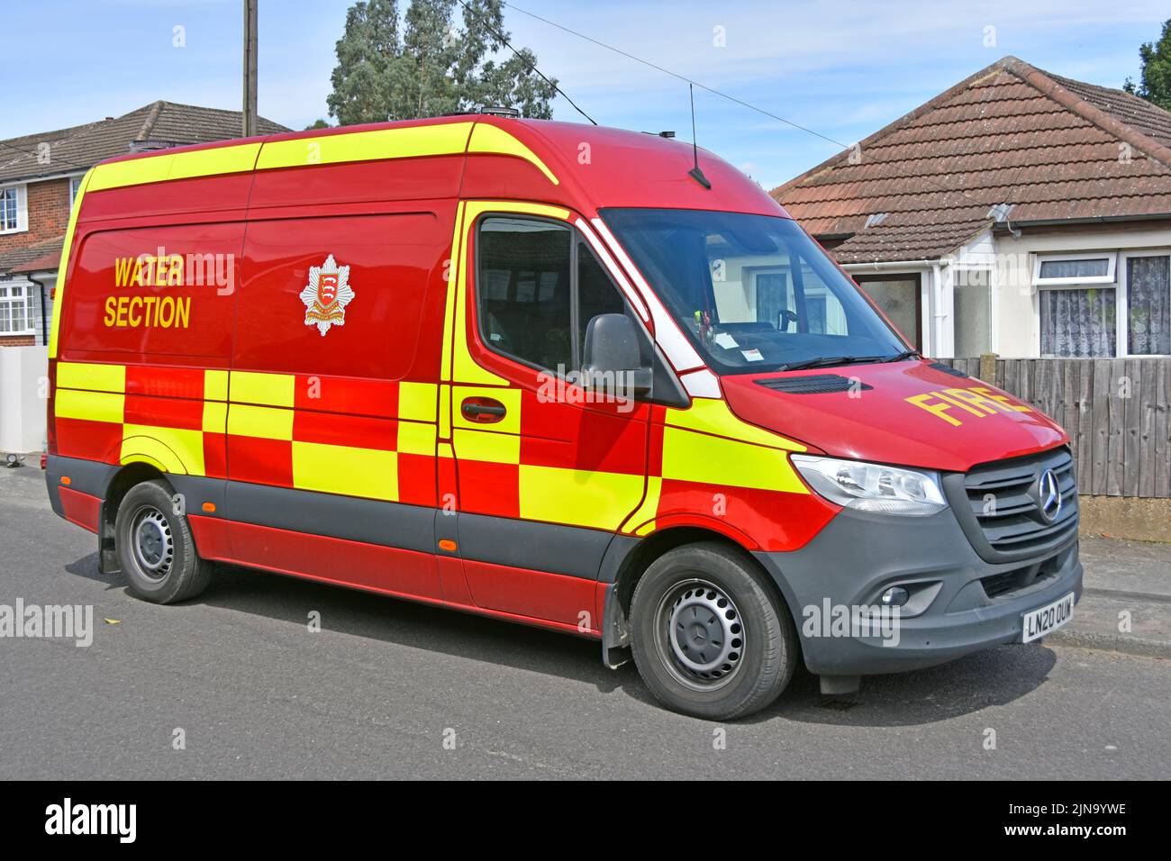 Essex Fire and Rescue Service Water Section a Mercedes fire brigade red van at locations to maintain street fire hydrants for any emergency England UK Stock Photo