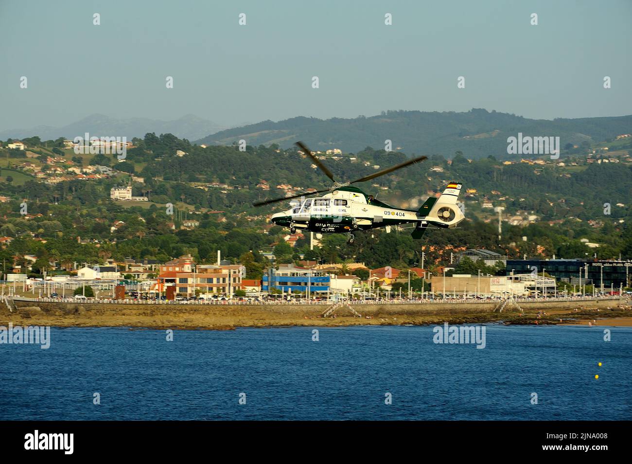 Gijon, Spain - July 23, 2022. Guardia Civil Eurocopter AS365 Dauphin flying over the coast at Gijon International Air festival 2022. Stock Photo