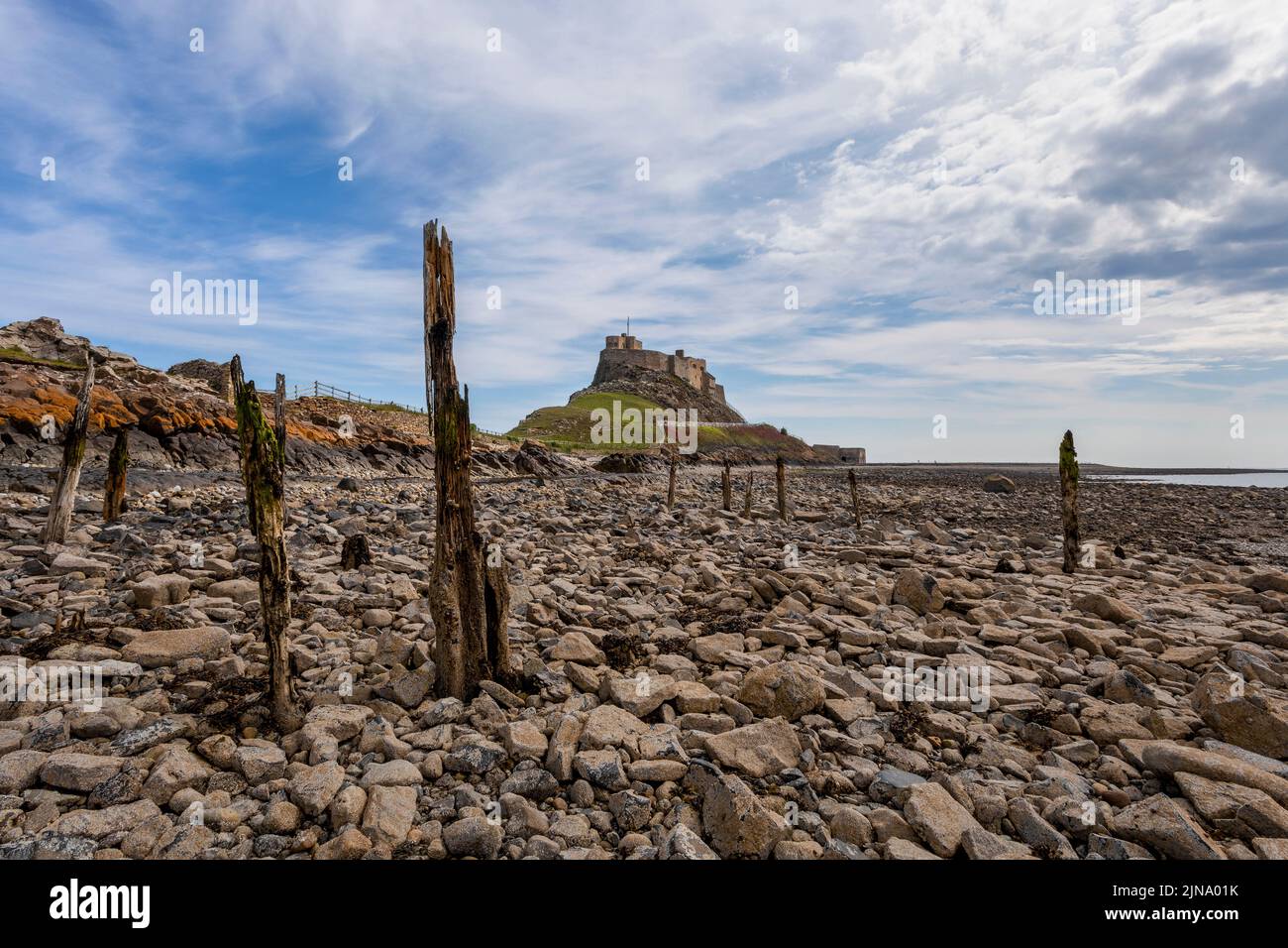 lindisfarne castle holy island from the jetty posts on the shore no people Stock Photo