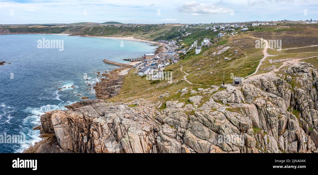 sennen cove cornwall showing rocky shore beach village cliffs and lifeboat station elevated view panorama Stock Photo