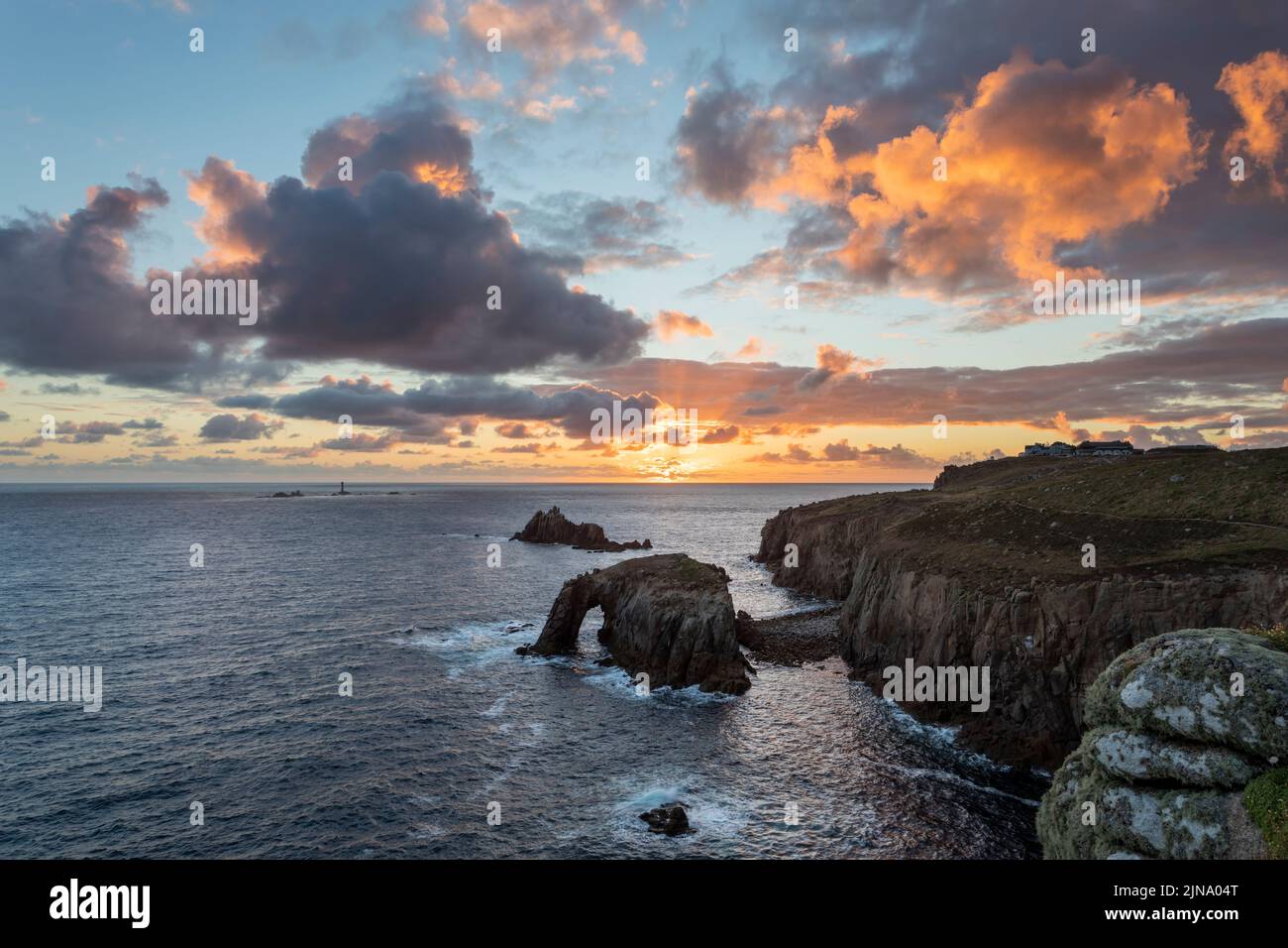 sunset at lands end cornwall with enys dodnan and the armed knight rock