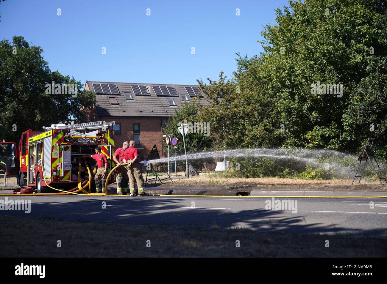 London Fire Brigade dealing with the aftermath of a grass fire in Rainham, east London. The Met Office has issued an amber warning for extreme heat covering four days from Thursday to Sunday for parts of England and Wales as a new heatwave looms. Picture date: Wednesday August 10, 2022. Stock Photo