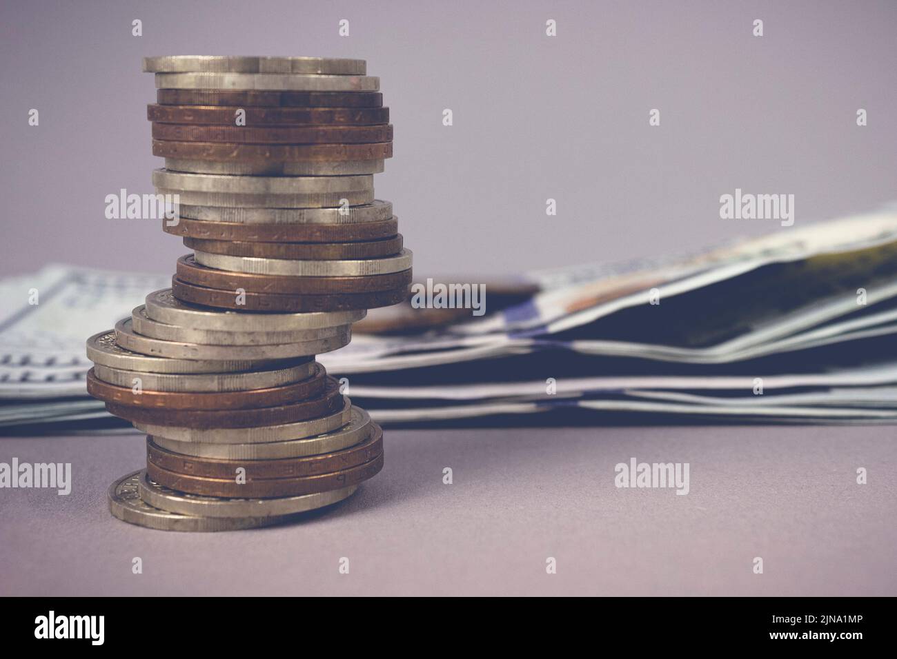 Selective focus of coins stacks on dollar banknotes with blurred background. Business growth, progress or success concept Stock Photo