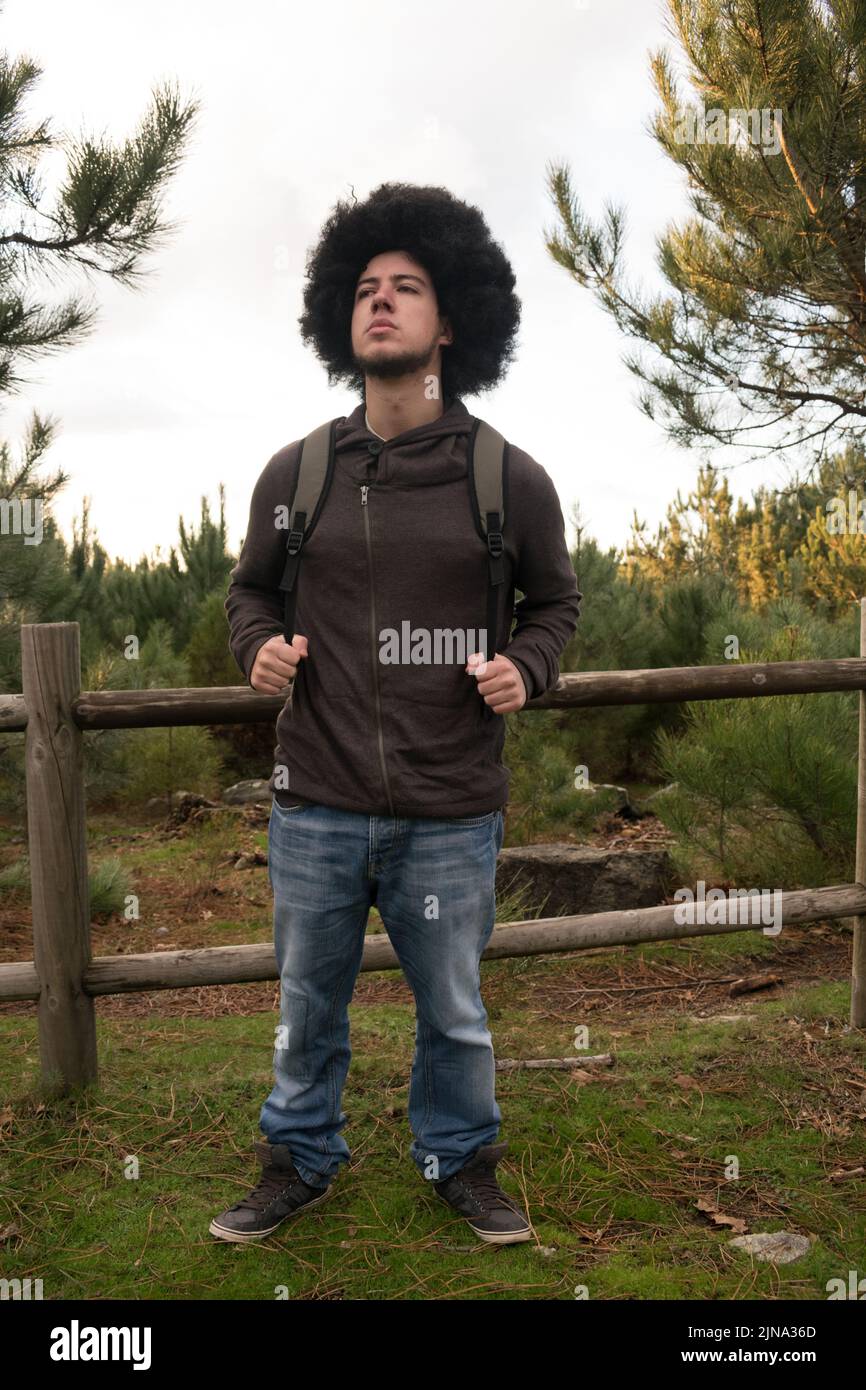 Attractive young guy with afro hair in the forest Stock Photo