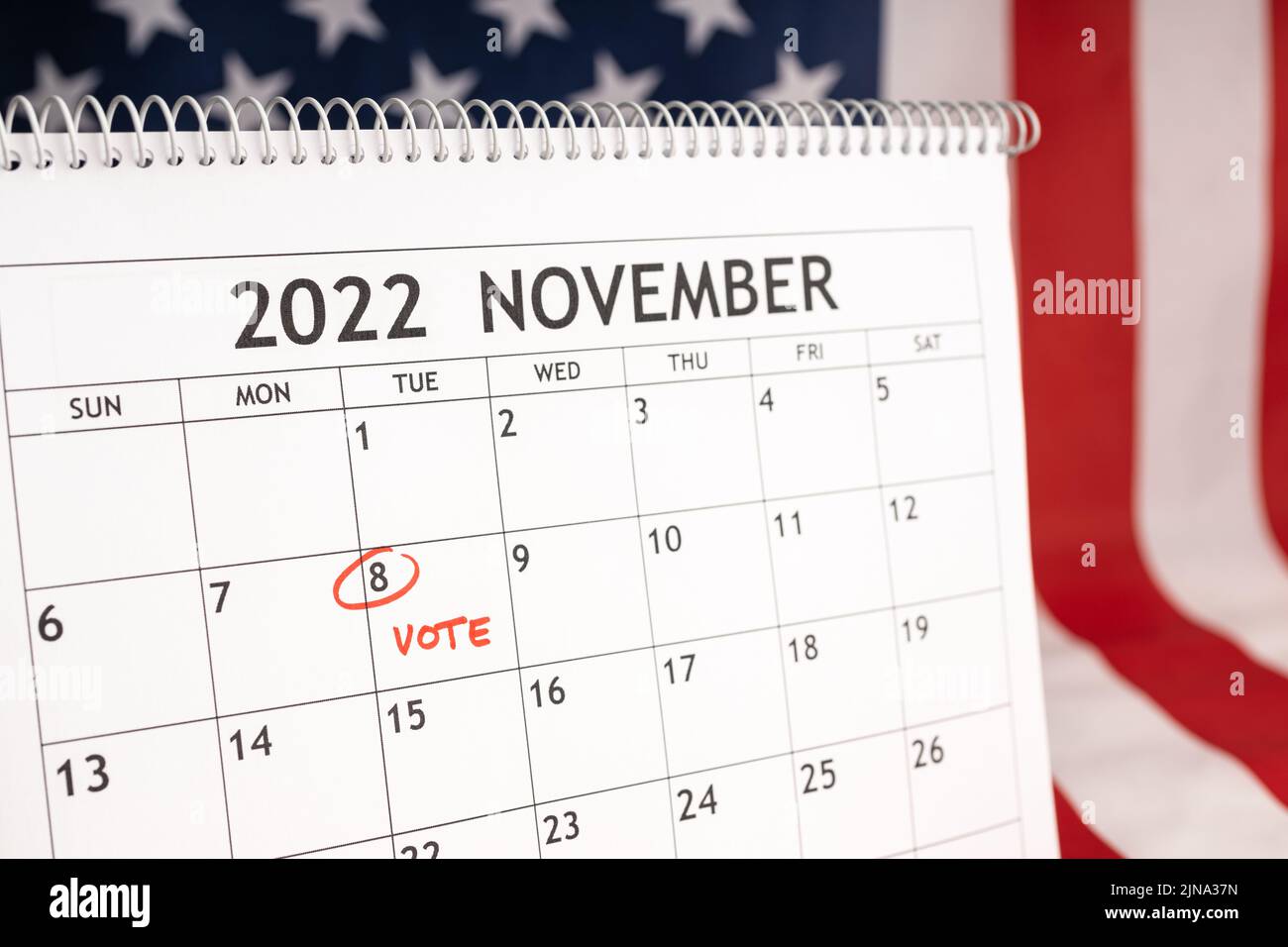 November 2022 America Vote day concept. Desk calendar with November 8 marked in red and USA flag at background Stock Photo