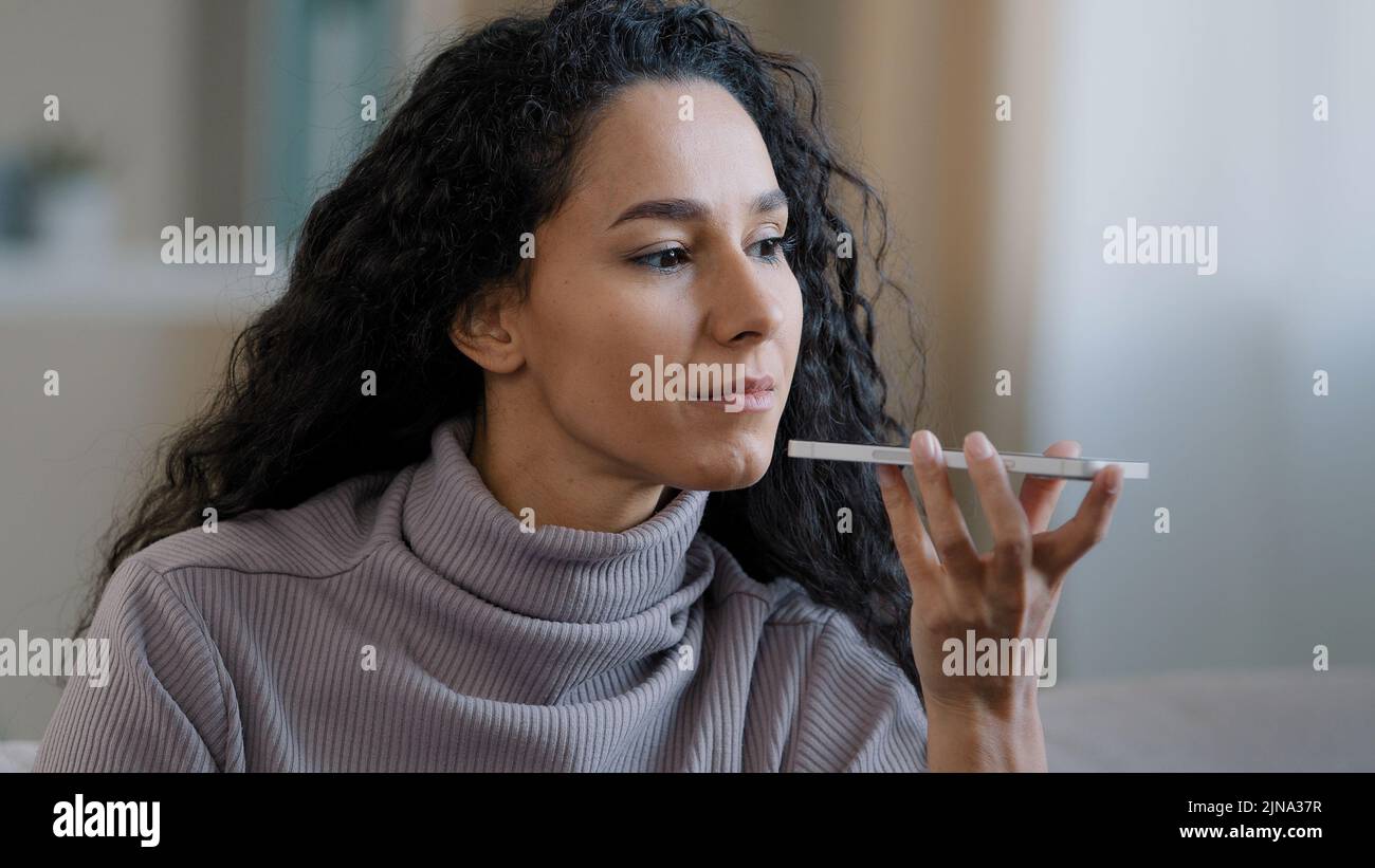 Close-up smiling happy young woman talk on speakerphone record audio ...