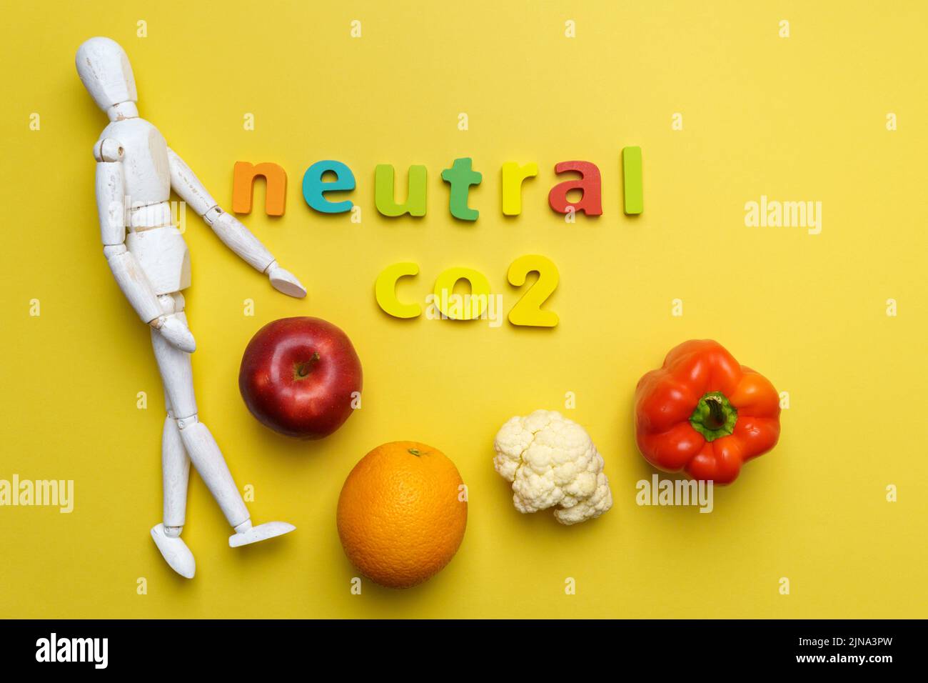 Local organic vegetables and fruits with carbon neutral emission label. Top view. Yellow background Stock Photo