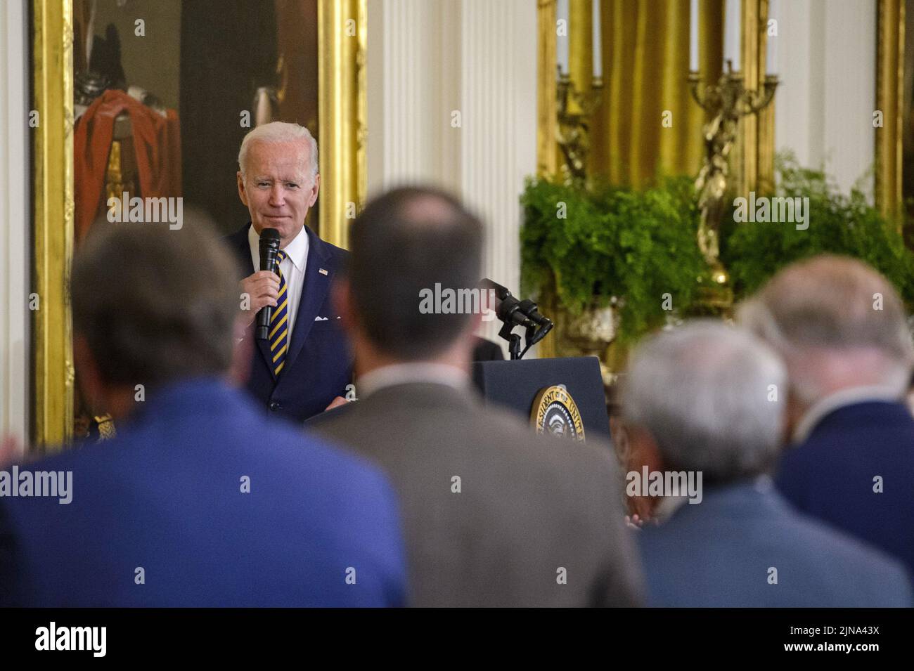 Washington, United States. 10th Aug, 2022. President Joe Biden looks on at members of Congress who helped pass the PACT Act, a bill to expand health care benefits for veterans exposed to toxic burn pits, during a signing ceremony in the East Room of the White House in Washington, DC on Wednesday, August 10, 2022. Photo by Bonnie Cash/UPI Credit: UPI/Alamy Live News Stock Photo