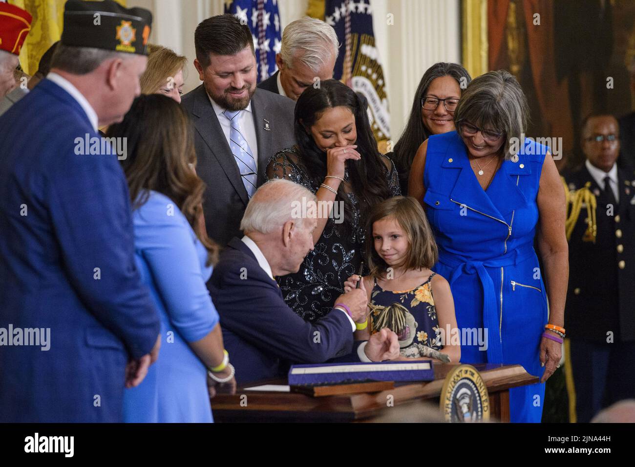 Washington, United States. 10th Aug, 2022. President Joe Biden hands Brielle Robinson, daughter of Sgt. First Class Heath Robinson, the pen he used to sign the PACT Act of 2022, a bill to expand health care benefits for veterans exposed to toxic burn pits, in the East Room of the White House in Washington, DC on Wednesday, August 10, 2022. Photo by Bonnie Cash/UPI Credit: UPI/Alamy Live News Stock Photo