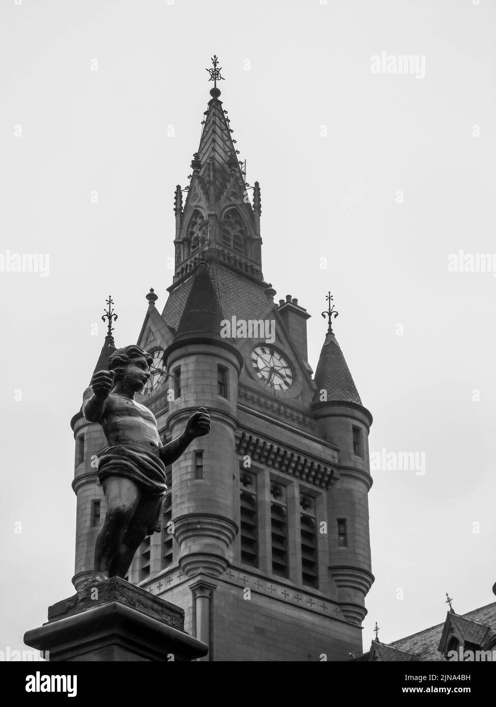 Black and white view of the Tolbooth in Aberdeen, Scotland, with the lead figurine of a boy called the Mannie in the foreground Stock Photo