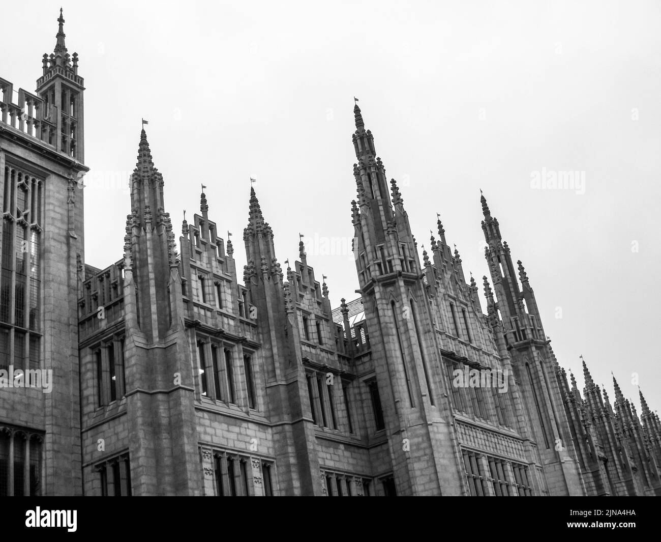 The detailed granite carved spires of Mariscal collage in the city of Aberdeen Scotland in black and white Stock Photo
