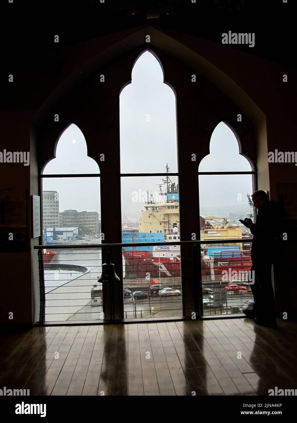 Looking through a window at the ships in Aberdeen Harbor, Scotland, on a cold rainy day Stock Photo