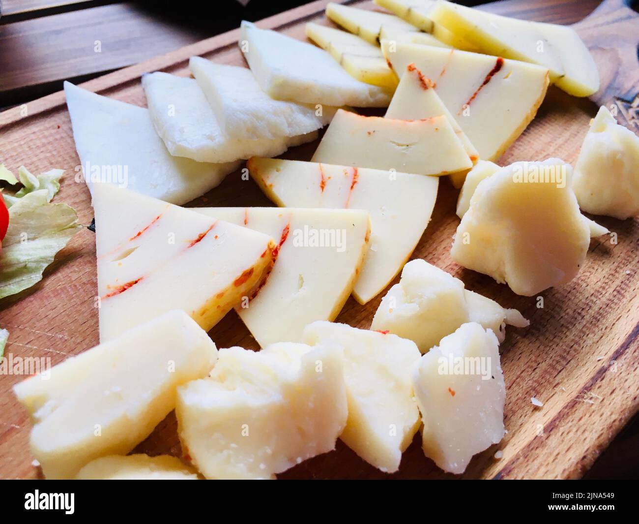 Close-Up of assorted cheeses on a chopping board Stock Photo
