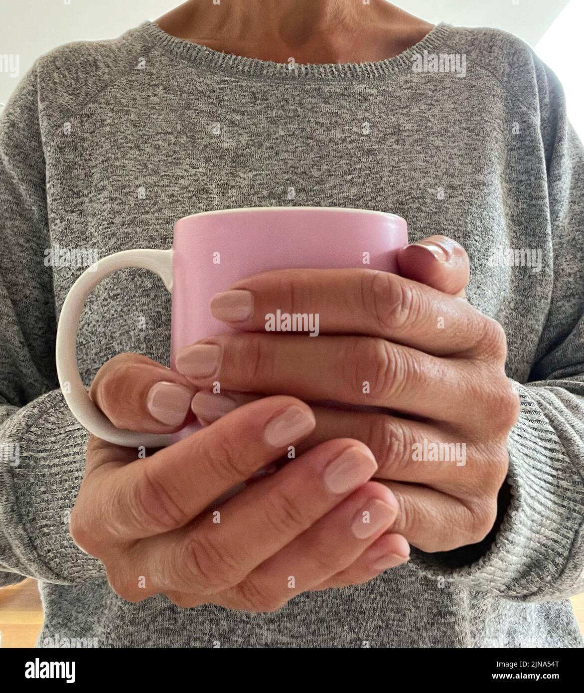 Close-Up of a woman holding a hot drink Stock Photo