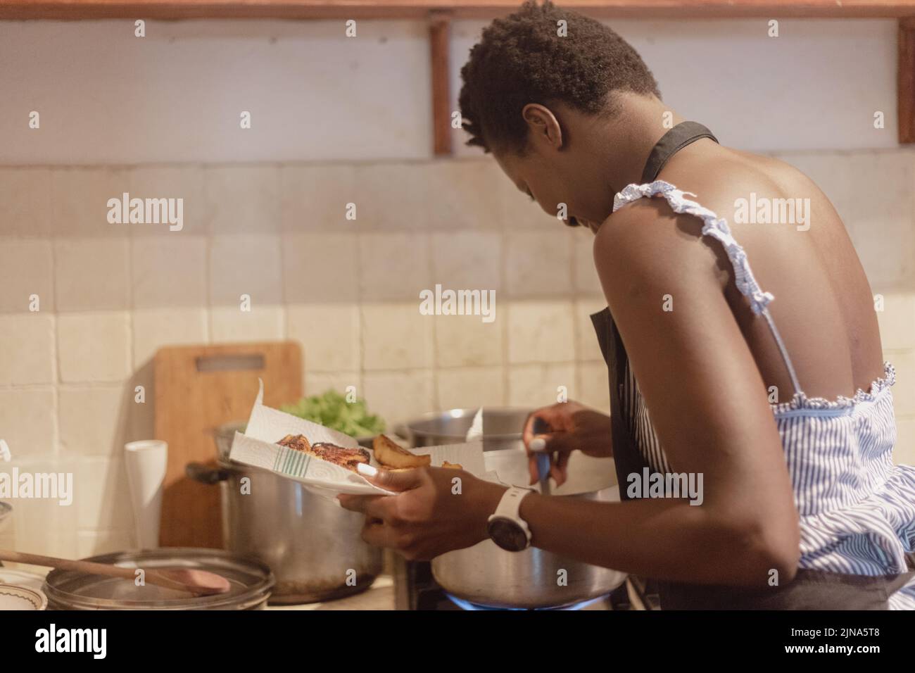 woman chef preparing african caribbean food with plantain plane tree fruit Stock Photo