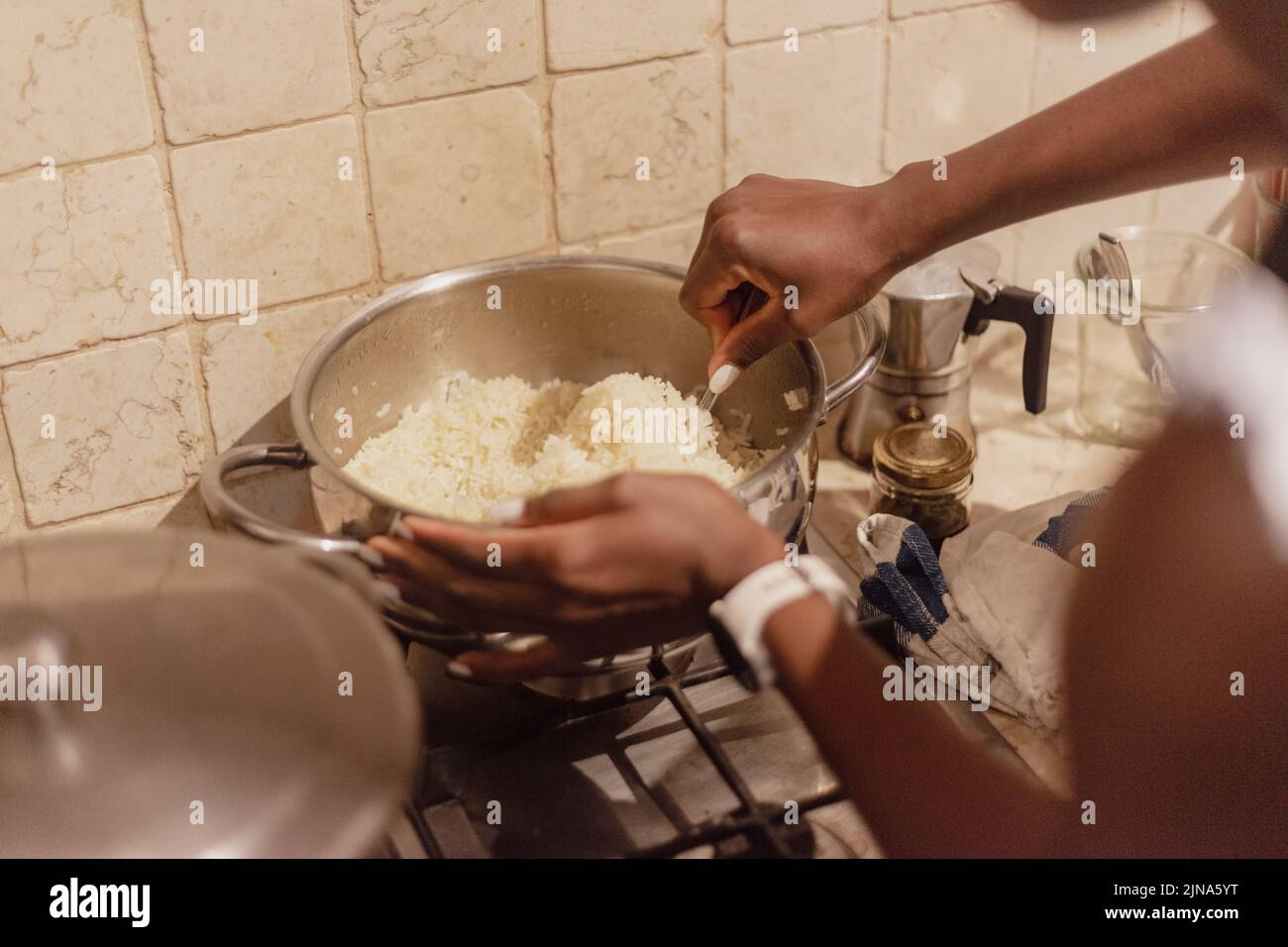 preparing rice for side dish at home woman hand detail Stock Photo