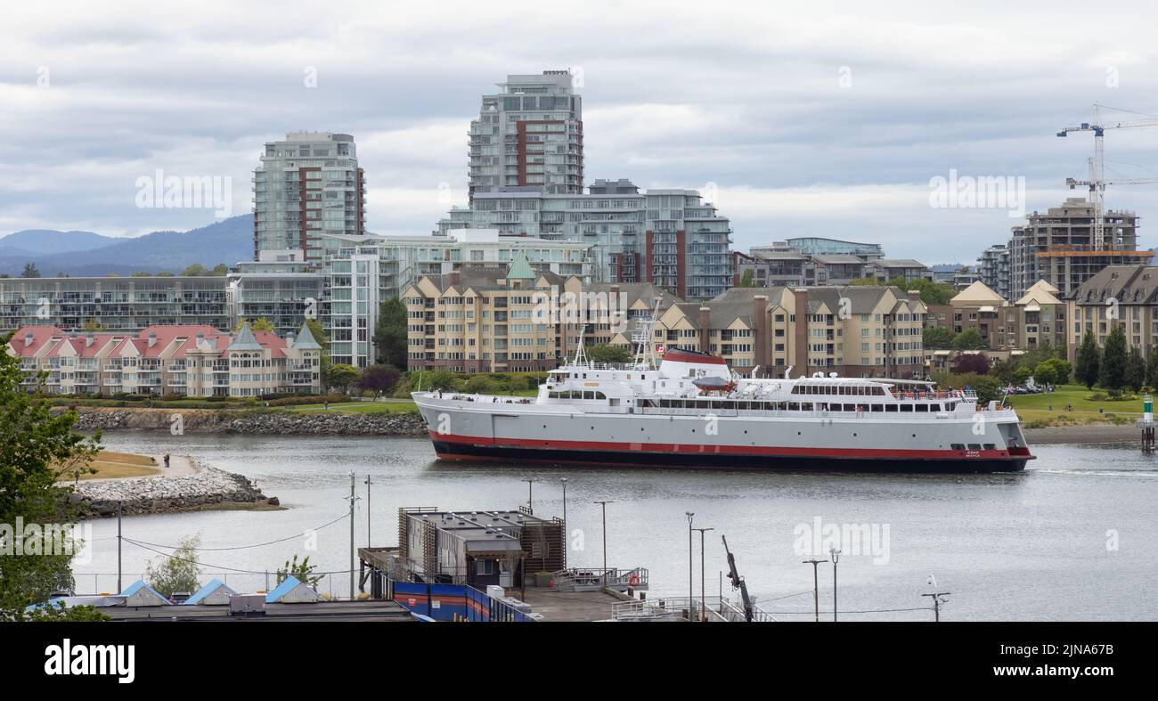 Ferry in Downtown Victoria Harbour during cloudy day Stock Photo - Alamy