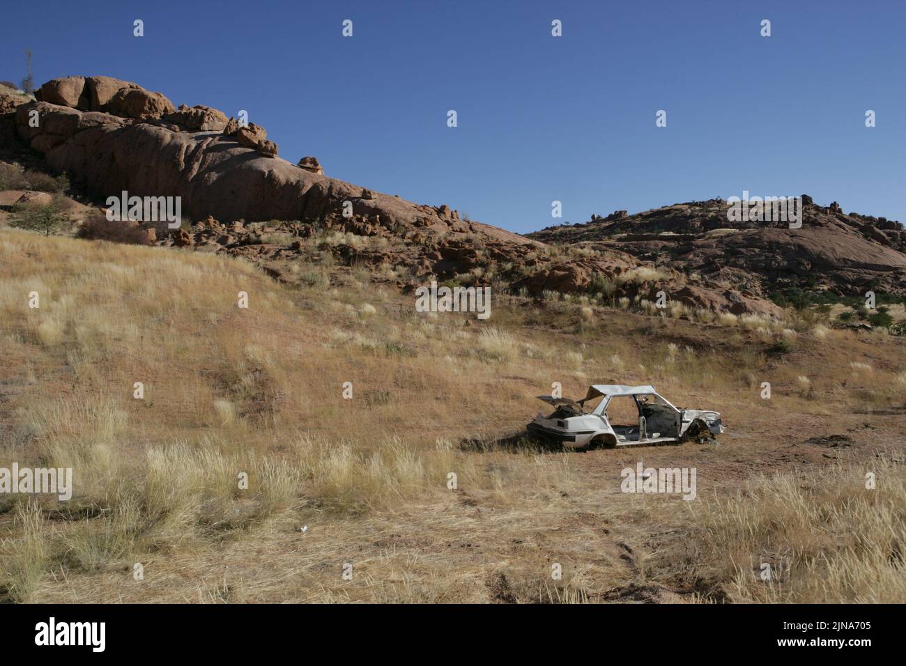 Abandoned car wreckage at the side of a road, Namib Desert, Namibia Stock Photo