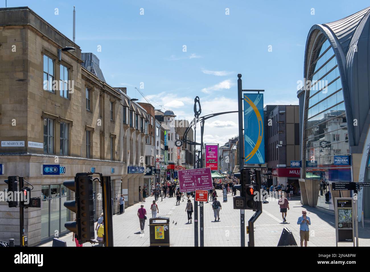 People walking around the Haymarket, on Northumberland Street, the main street in the city centre of Newcastle upon Tyne, UK. Stock Photo