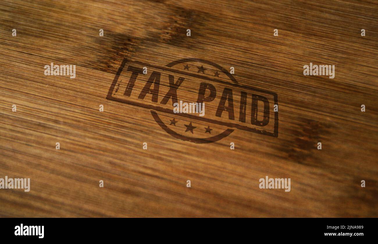 Tax paid stamp printed on wooden box. Business taxes and income taxation concept. Stock Photo