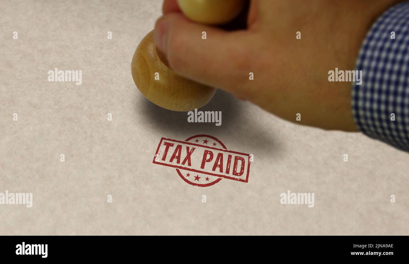 Tax paid stamp and stamping hand. Business taxes and income taxation concept. Stock Photo