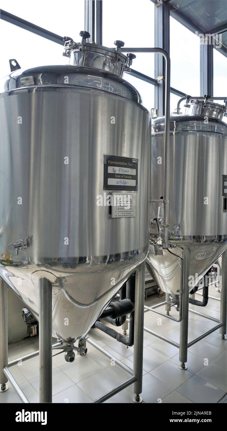 Row of shiny metal micro brewery tanks or Fermentation mash vats in