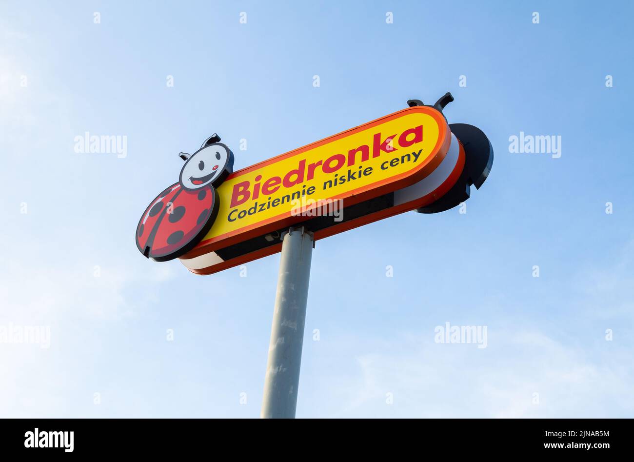 Biedronka supermarket shop logo sign. Retail chain of discount shops in Poland. Convenience grocery store logotype signboard, Polish shopping center. Stock Photo