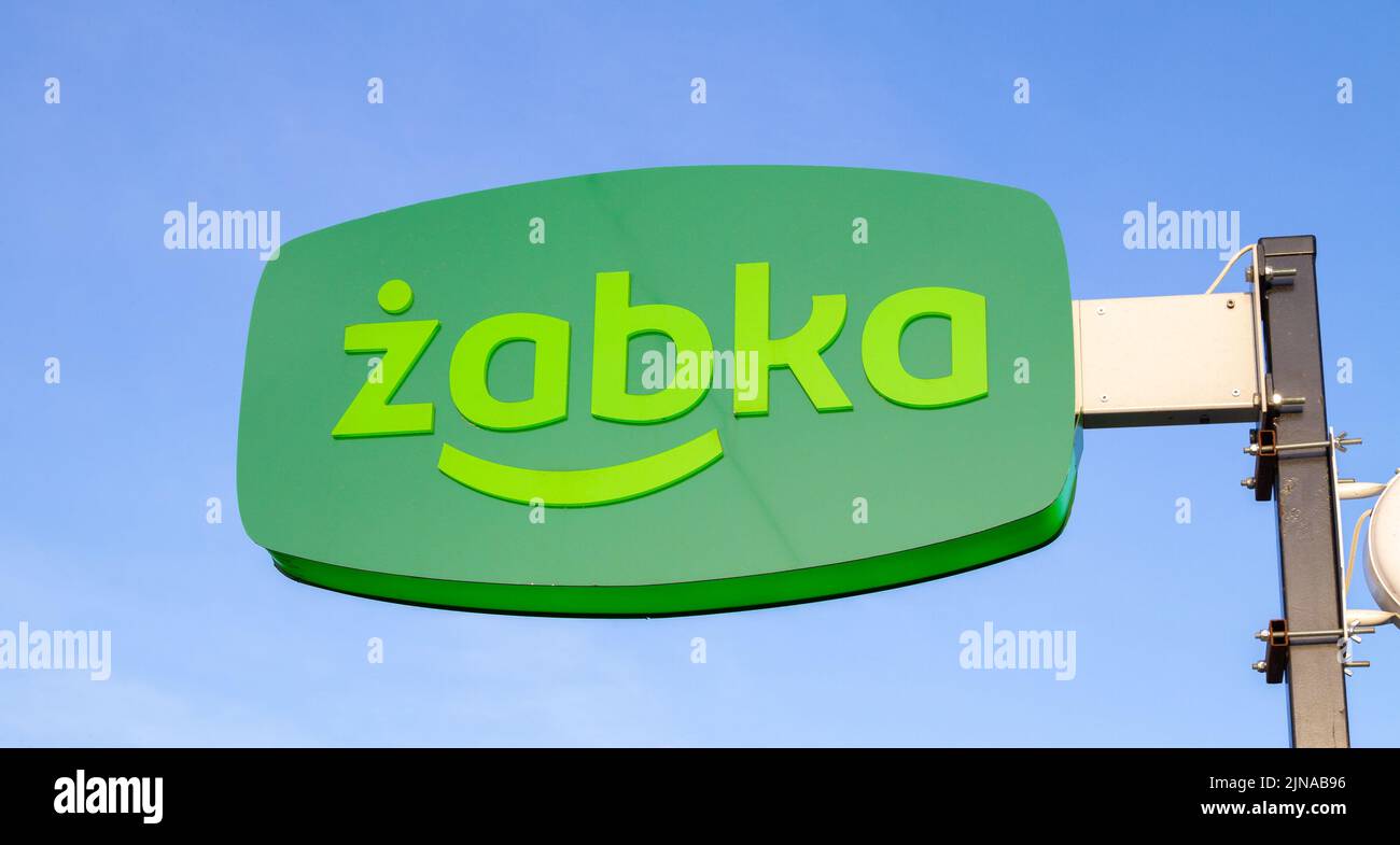 Żabka shop signboard with brand logo sign. Zabka chain of small convenience grocery stores in Poland. Stock Photo
