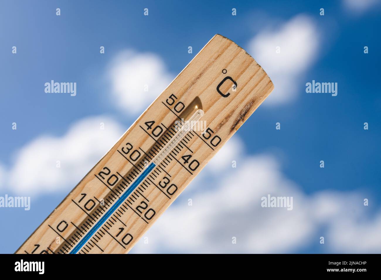 Thermometer Made Of Wood With The Temperature 35 Degrees Celsius, Symbol Image Heat And Warmth In Summer, High Temperatures Stock Photo