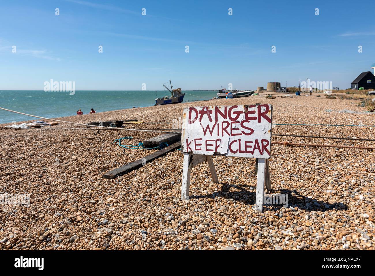 A danger sign on Fisherman’s Beach, Hythe, Kent. Stock Photo