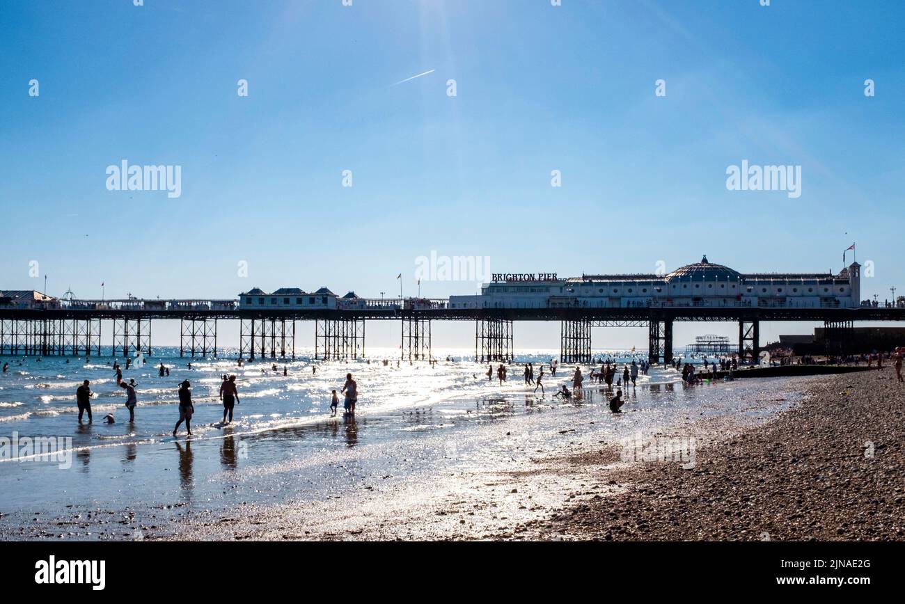 Brighton UK 10th August 2022 - Brighton Beach is packed with people at the end of a scorching hot sunny day as another heatwave begins with an amber warning being issued in parts of the South East  : Credit Simon Dack / Alamy Live News Stock Photo