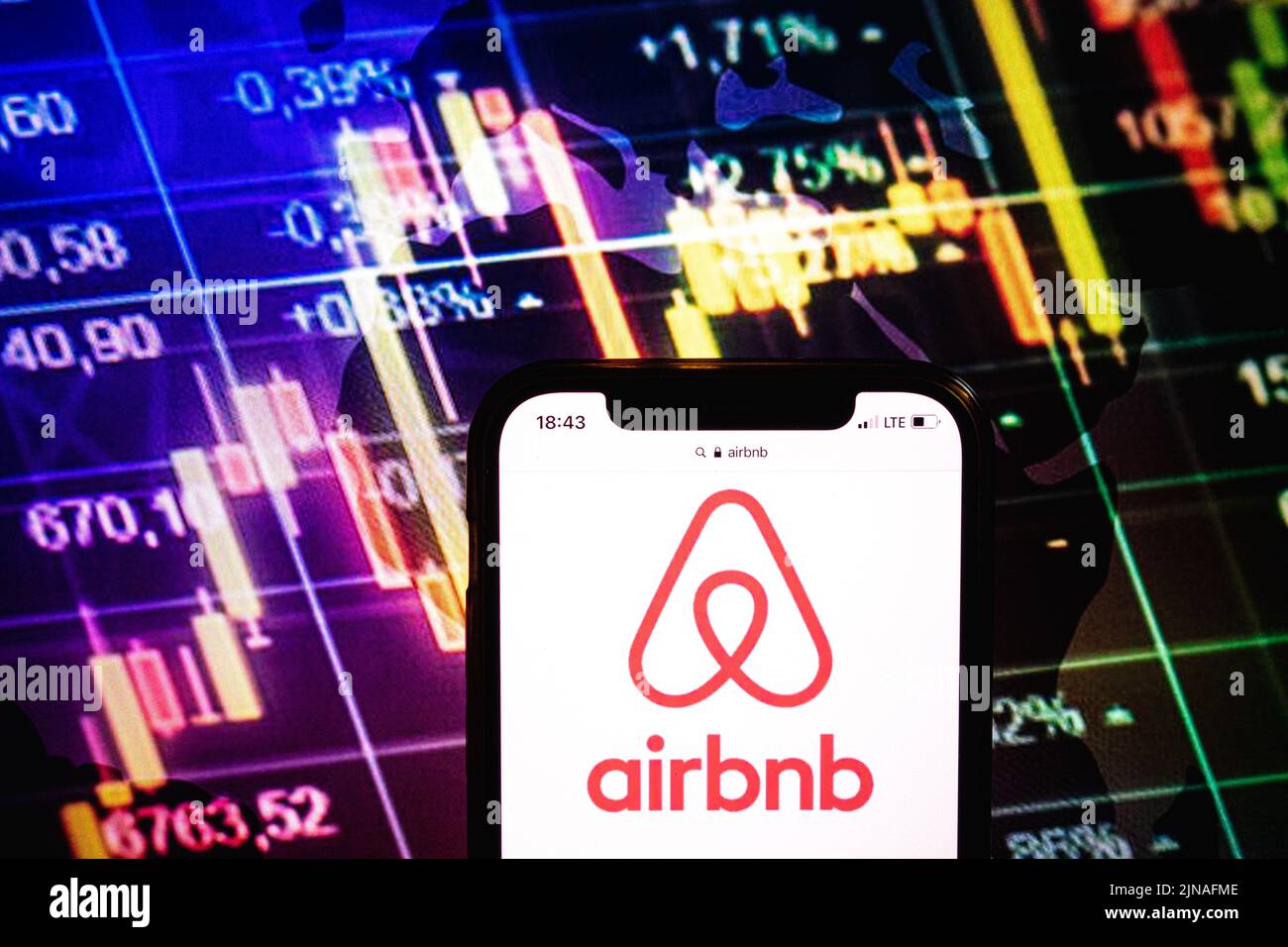 KONSKIE, POLAND - August 09, 2022: Smartphone displaying logo of Airbnb company on stock exchange diagram background Stock Photo