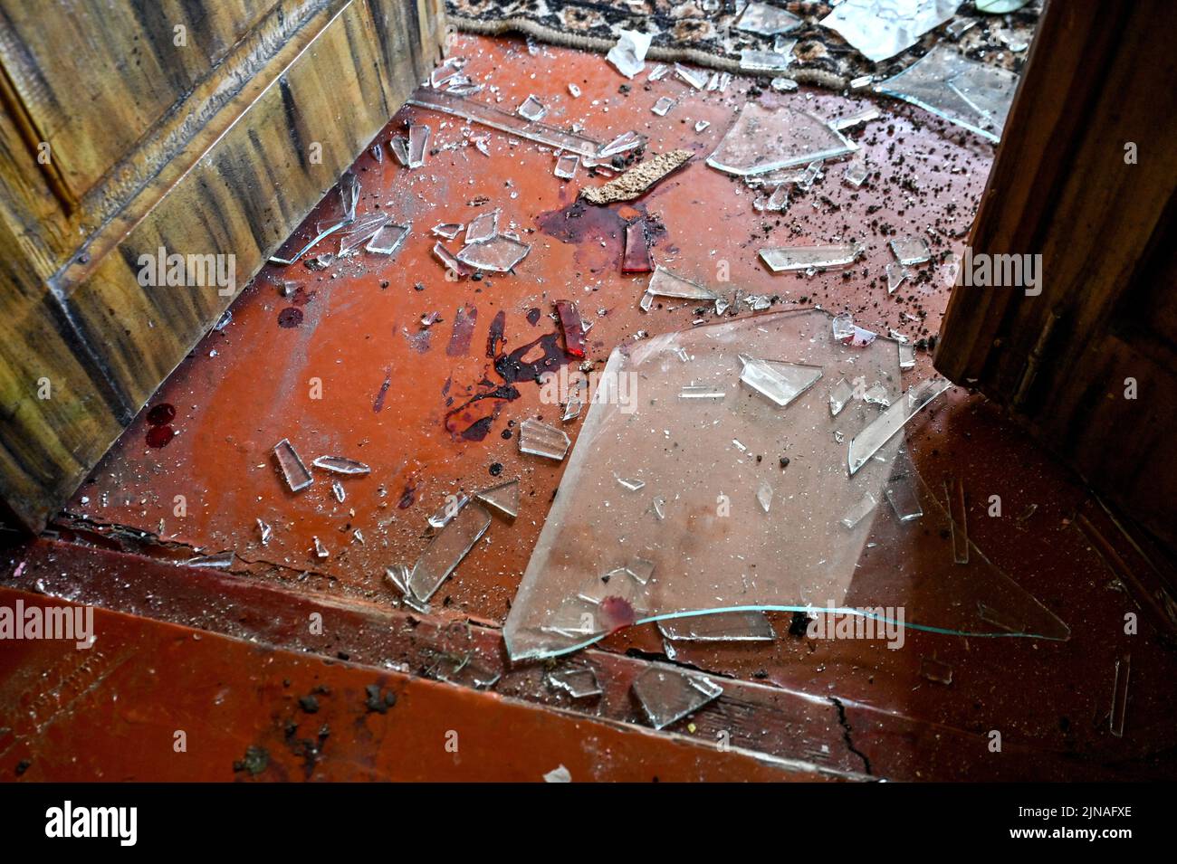 KUSHUHUM, UKRAINE - AUGUST 10, 2022 - The shards of glass cover the floor in a house damaged by Russian shelling, Kushuhum urban-type settlement, Zapo Stock Photo