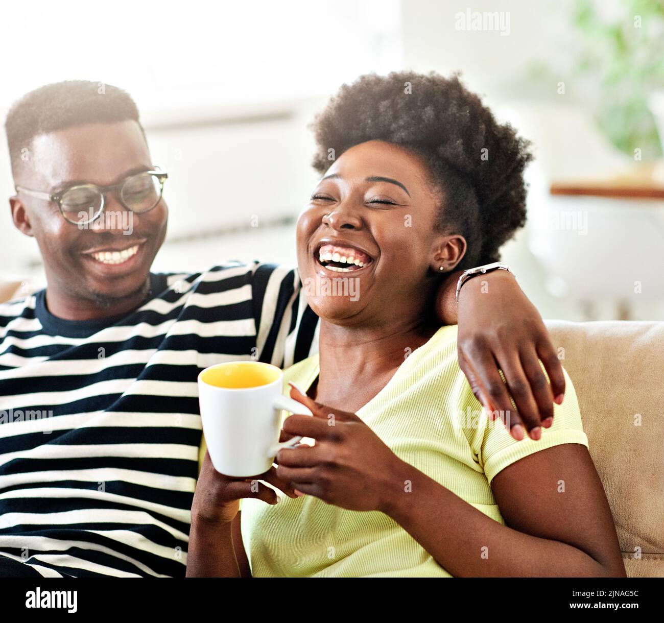 woman couple man happy happiness love black young lifestyle together romantic boyfriend girlfriend laughing hug coffee tea cup mug Stock Photo