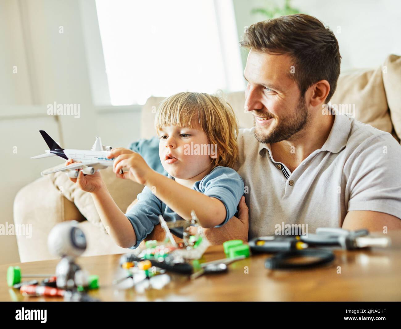 child son father family happy playing kid childhood dad love fun smiling little man home toy airplane travel vacation plane holiday Stock Photo