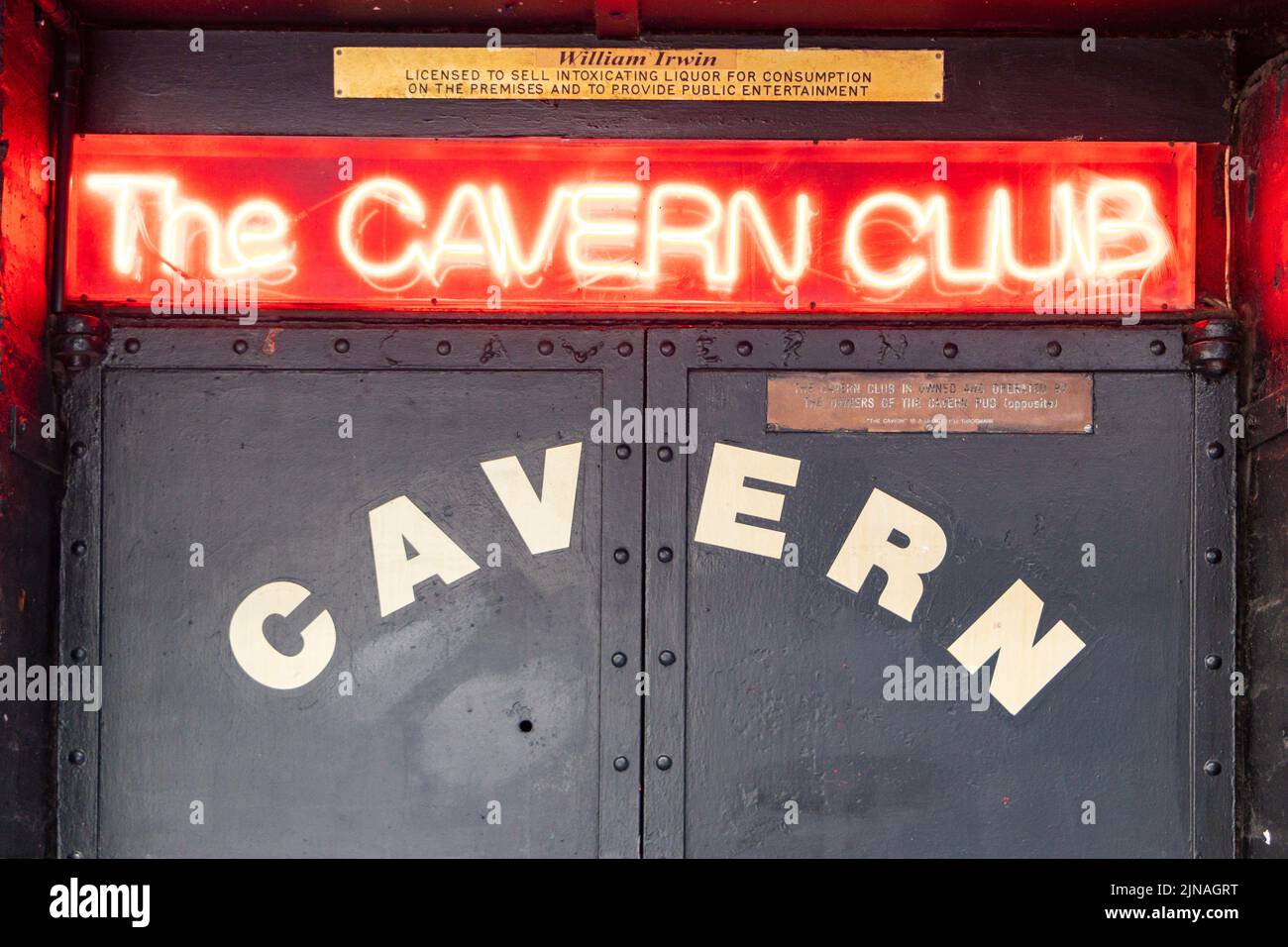 neon sign and doors to the Cavern Club wherwe the beatles played in the 1960s in Liverpool Merseyside Stock Photo