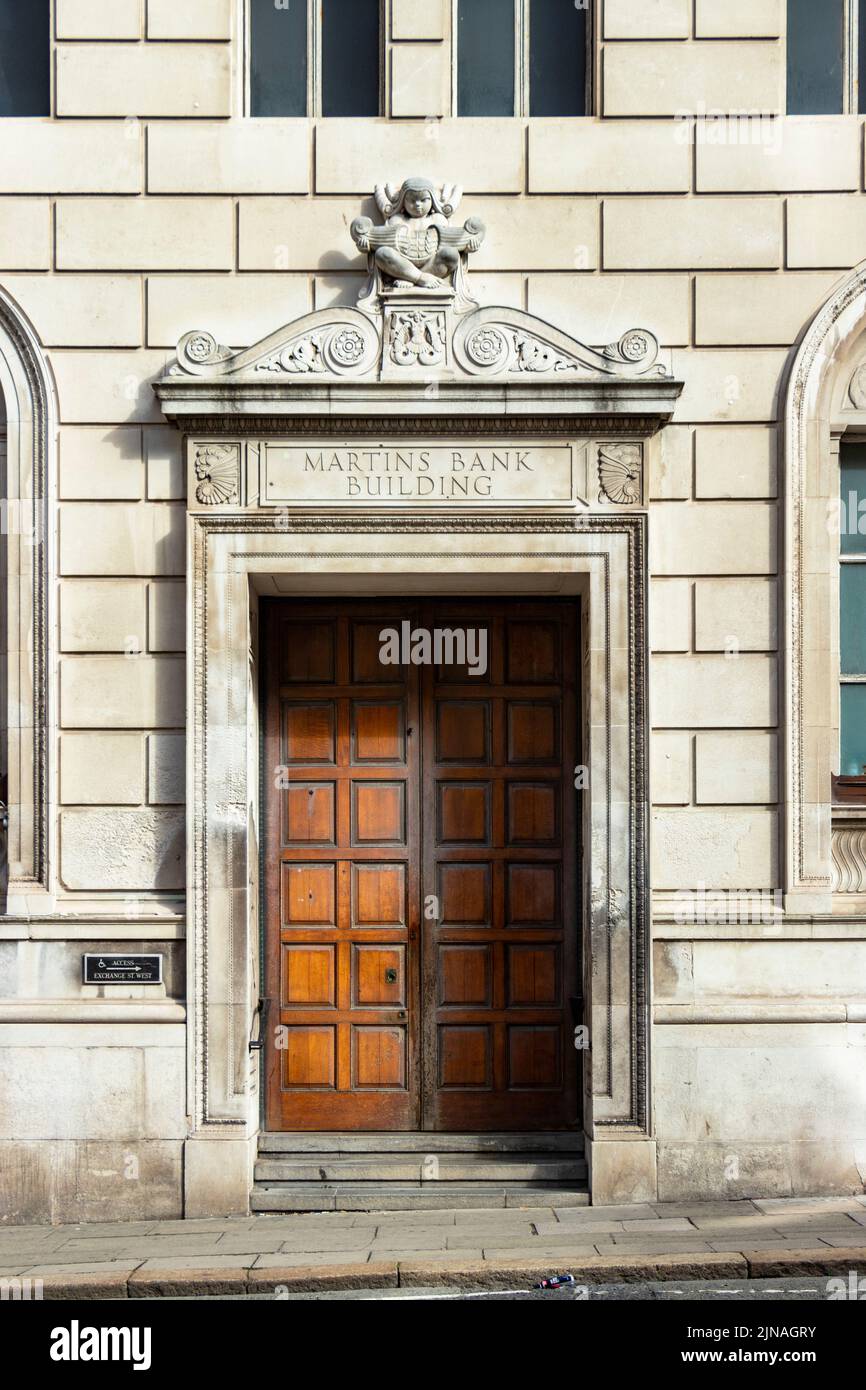 A historic wooden door entrance to the Martins Bank Building, showcasing classic architectural details and an engraved name above the doorway. Stock Photo