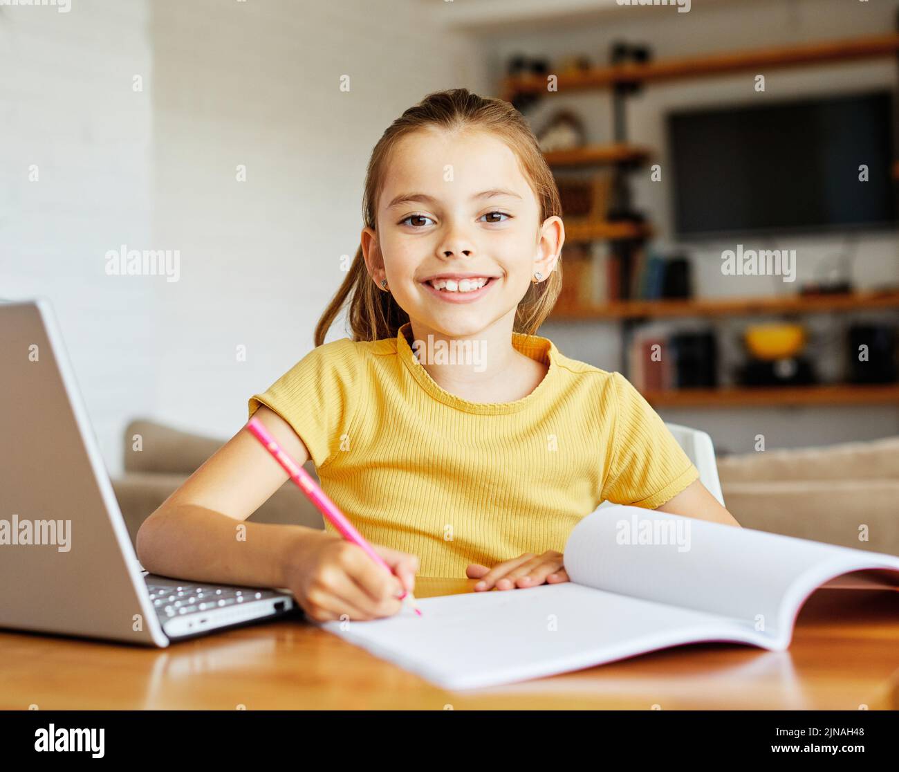 child laptop computer technology home girl education homework kid learning internet childhood student sitting connection using online Stock Photo