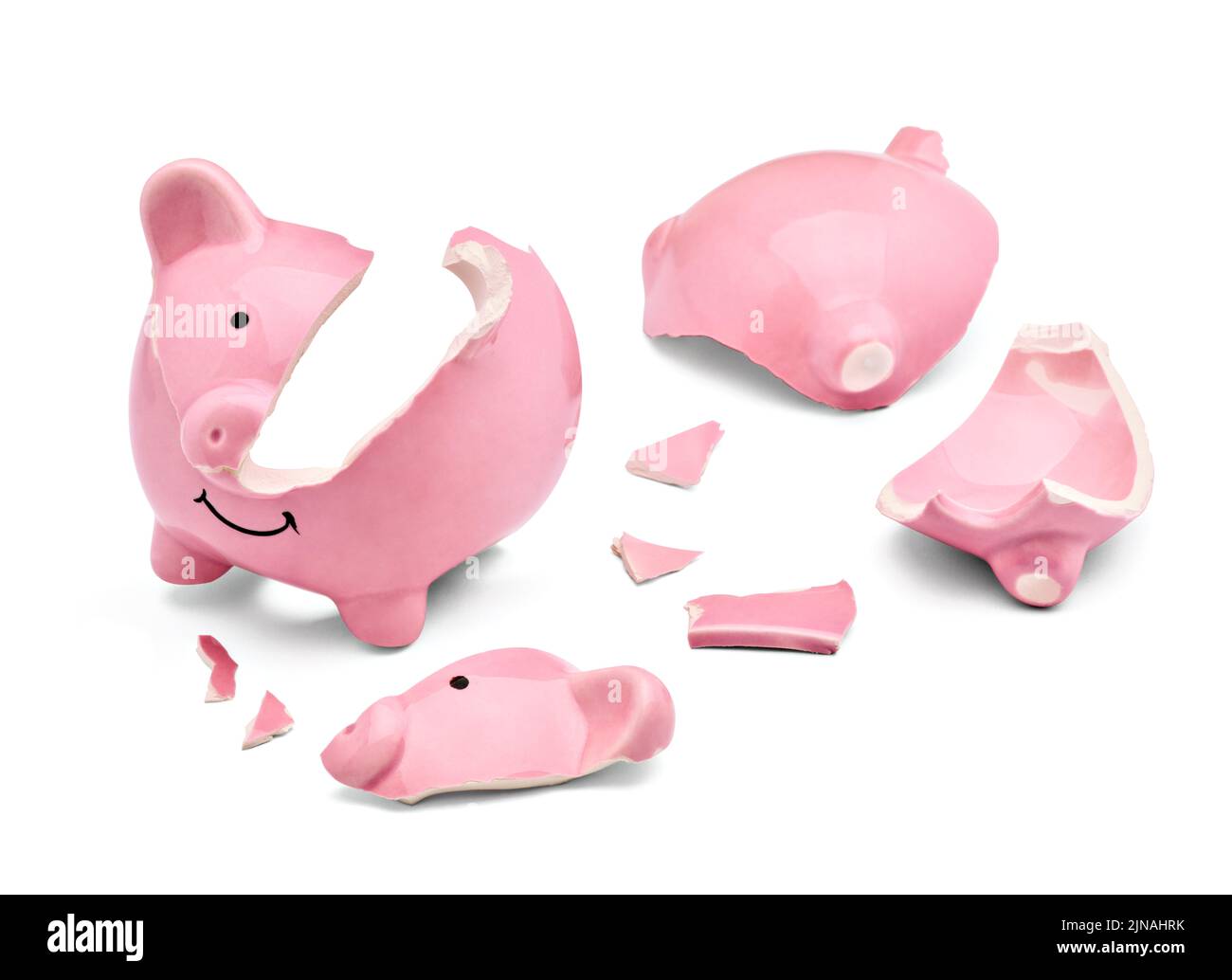 Close up of a broken pink piggy bank on white background Stock Photo