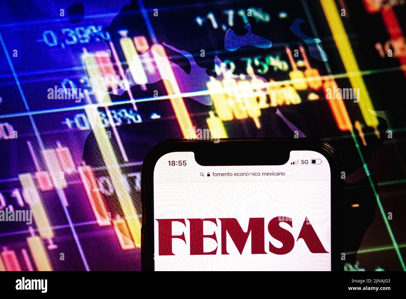 KONSKIE, POLAND - August 09, 2022: Smartphone displaying logo of Fomento Economico Mexicano company on stock exchange diagram background Stock Photo