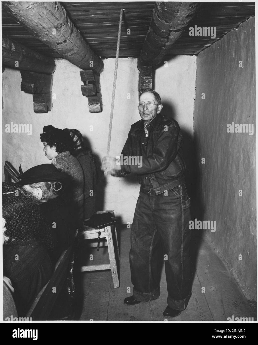 Taos County, New Mexico. Church bell is rung to call villagers to Mass ...