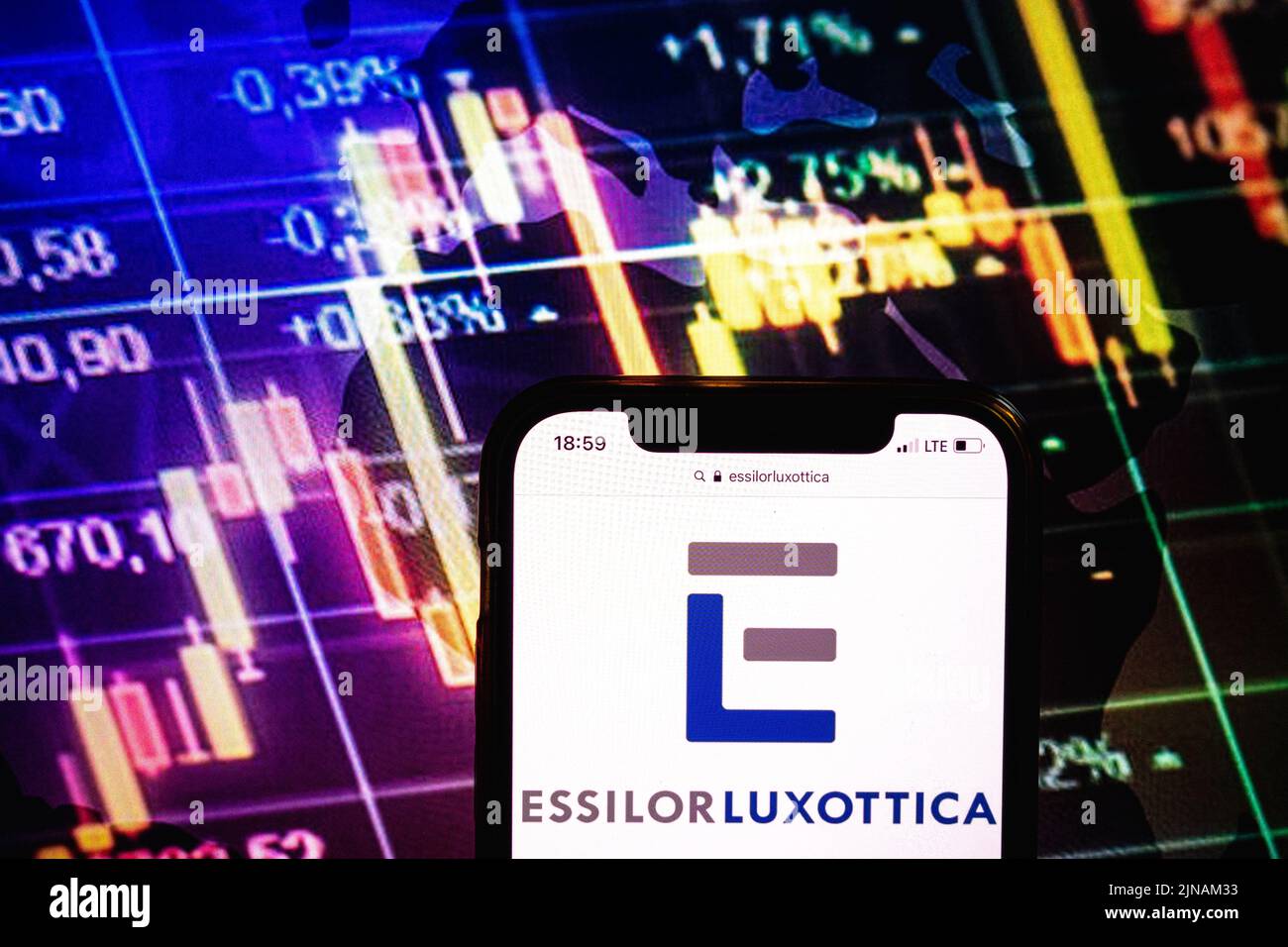 KONSKIE, POLAND - August 09, 2022: Smartphone displaying logo of EssilorLuxottica company on stock exchange diagram background Stock Photo